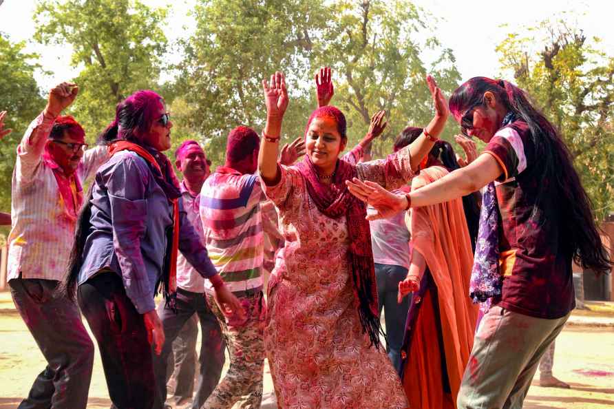 Police personnel celebrate Holi