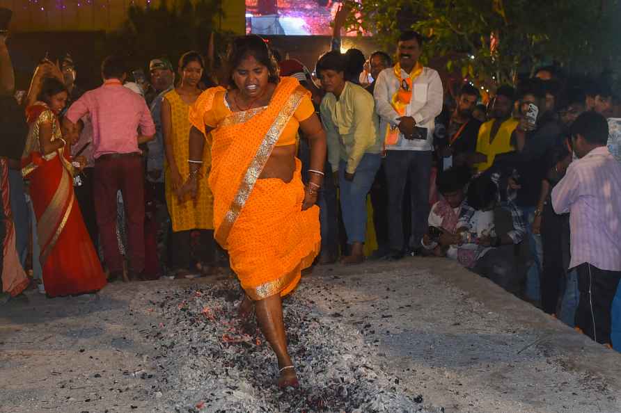 Ranchi: A tribal woman walks on the fire during Manda festival, ...