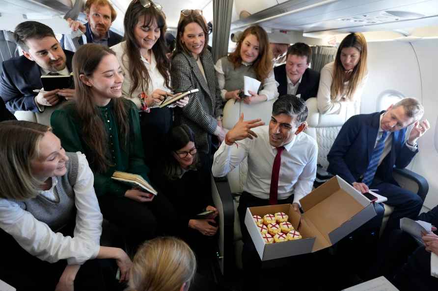 Britain's Prime Minister Rishi Sunak speaks to journalists on board...