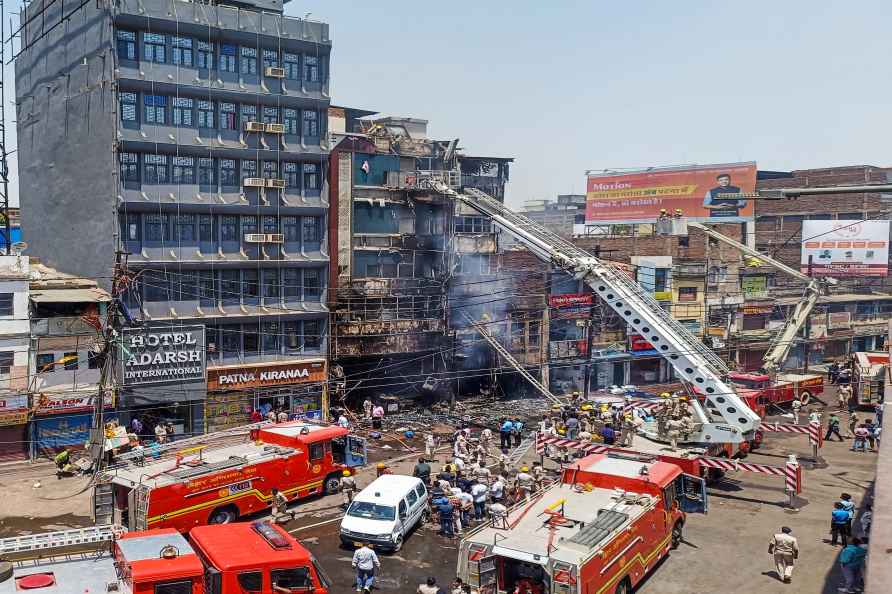 Patna: Firefighters douse a fire which broke out in a hotel near...