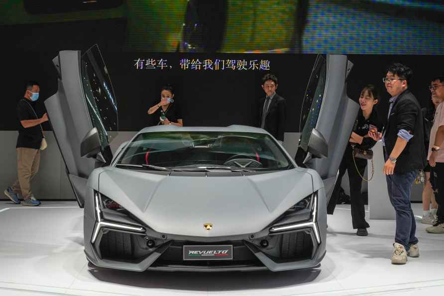 Visitors look at a Lamborghini car during the China Auto Show in...