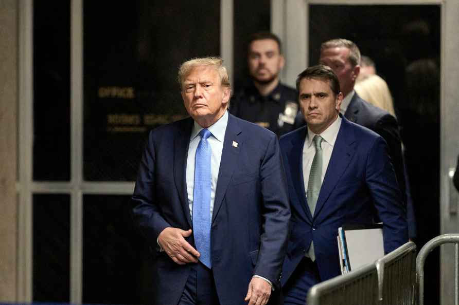 Former President Donald Trump, followed by his attorney Todd Blanche...