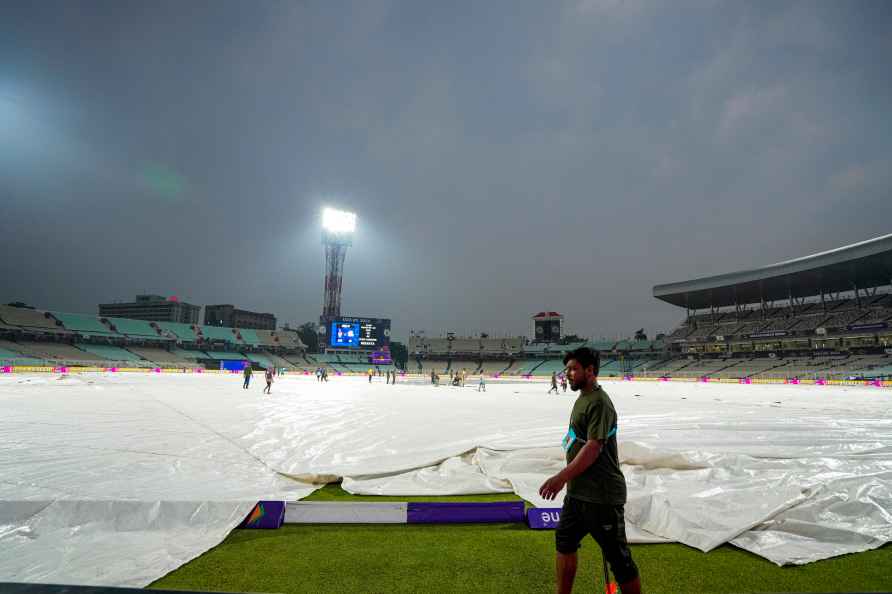 Kolkata: Ground staff covers the ground amid rain before an Indian...