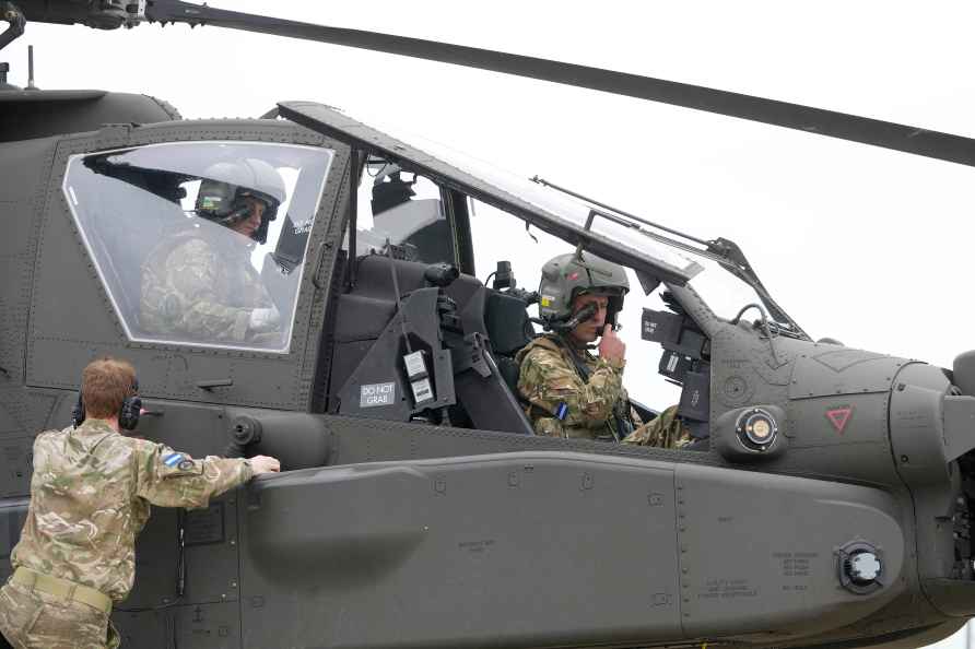 Britain's Prince William sits in an Apache helicopter at the Army...