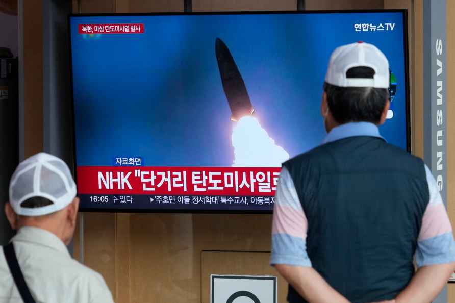 A TV screen shows a file image of North Korea's missile launch