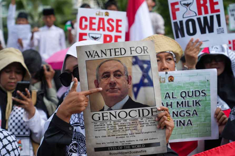 A protester holds a poster of Israeli Prime Minister Benjamin Netanyahu