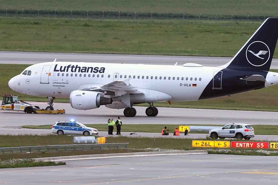 Climate activists lie on a access road for runways at the Munich airport