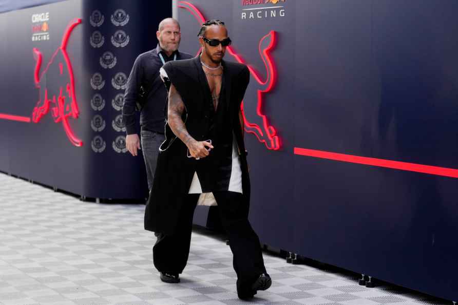 Mercedes driver Lewis Hamilton of Britain arrives in the paddock...