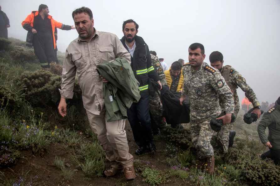 Rescue team members carry the body of President Ebrahim Raisi