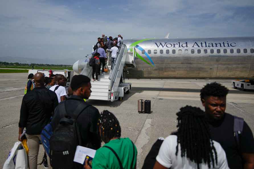 Passengers wait to board a World Atlantic plane