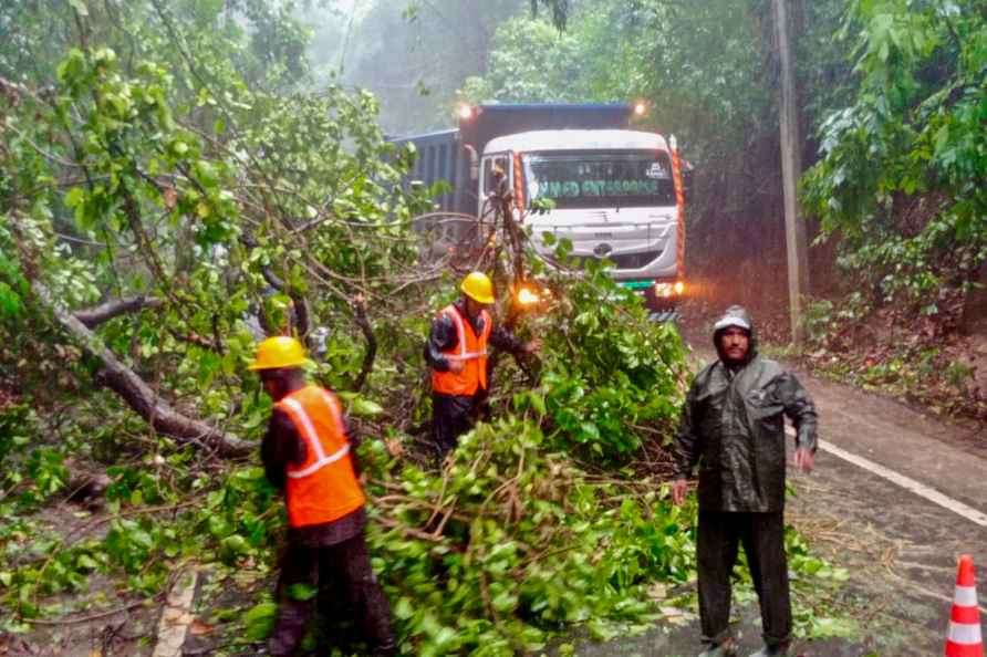 Sepahijala: Disaster response force personnel remove branches of...