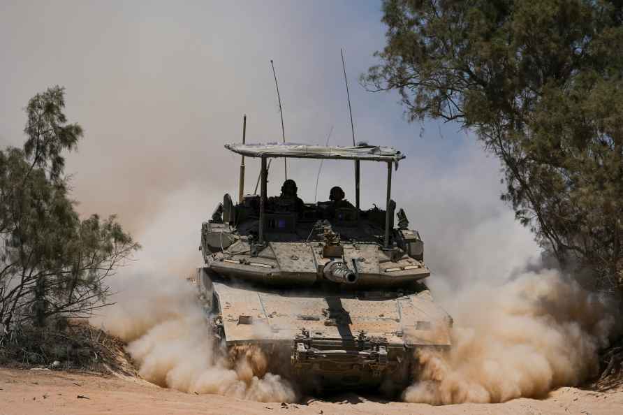 Israeli soldiers drive a tank