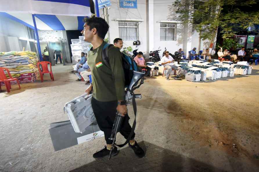 Patna: A security personnel carries an EVM to deposit at the strong...