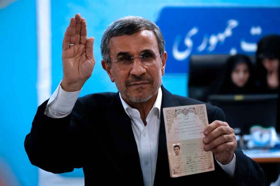 Iran's hard-line former President Mahmoud Ahmadinejad shows his ...