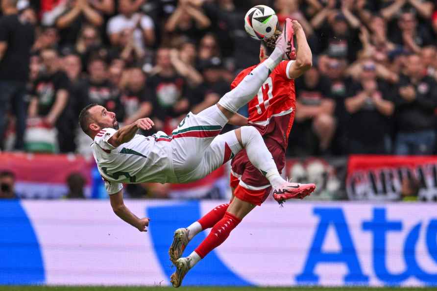 Hungary's Attila Fiola, left, and Switzerlands Ruben Vargas, right...