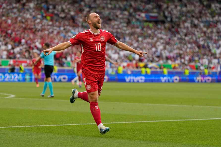 Denmark's Christian Eriksen celebrates after scoring the opening...