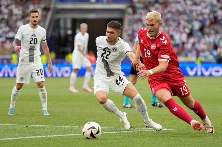 Denmark's Jonas Wind, right, gets past Slovenia's Adam Gnezda Cerin...