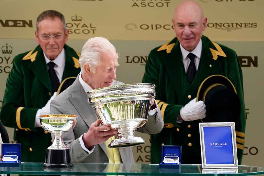 Britain's King Charles III prepares to present trophies to the owner...