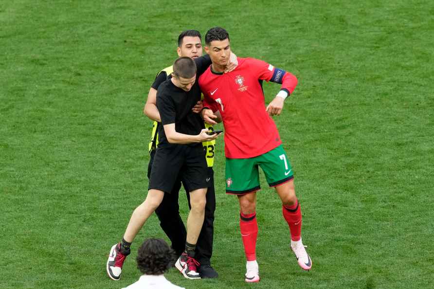 A pitch holds on to Portugal's Cristiano Ronaldo during a Group ...