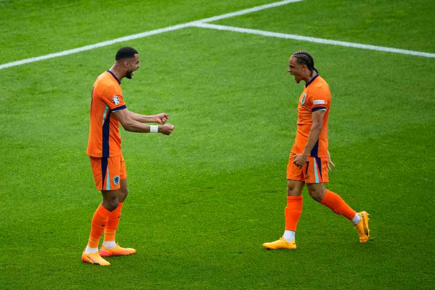 Cody Gakpo of the Netherlands, left, celebrates with teammate Xavi...