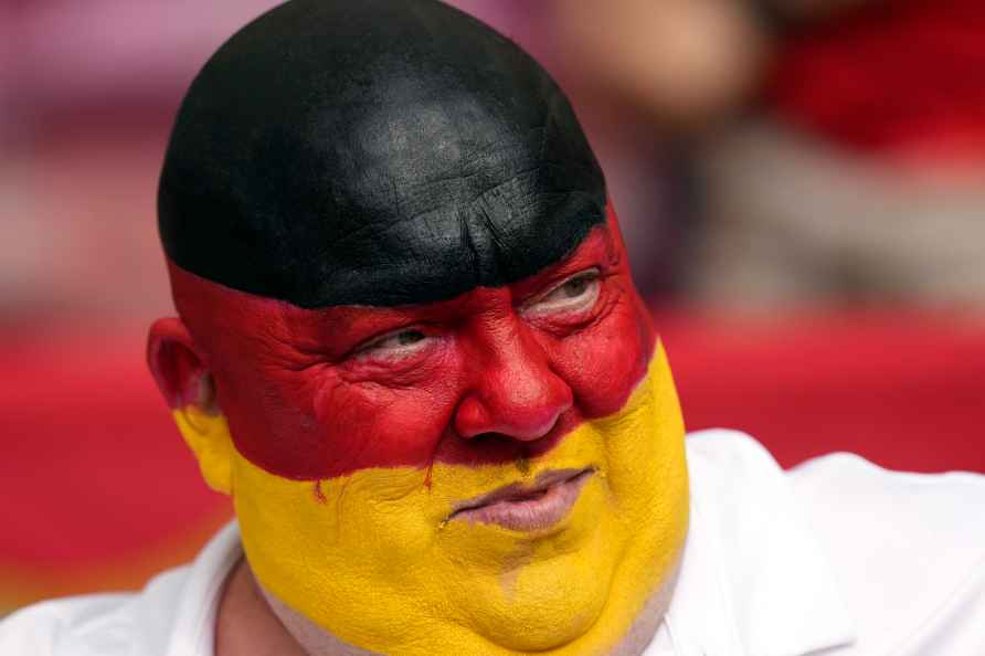 A Germany supporter, with his head painted