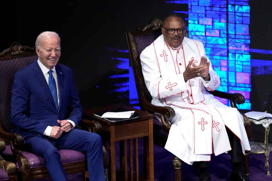 President Joe Biden, left, sits with Bishop Ernest C. Morris, Sr...