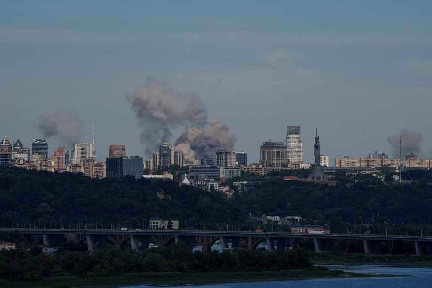 Smoke rises over the Kyiv skyline after a Russian attack, Monday...