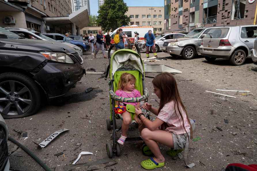 Children wait near the site of Okhmatdyt children hospital