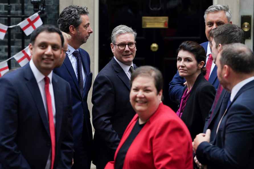 Britain's Prime Minister Keir Starmer, background center, poses ...