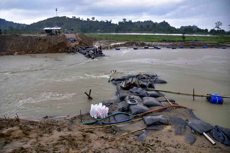 Nagaon: Workers use geo-bags to restore an embankment that was damaged...