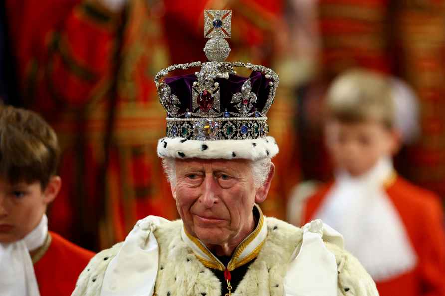 Britain's King Charles wears the Imperial State Crown on the day...