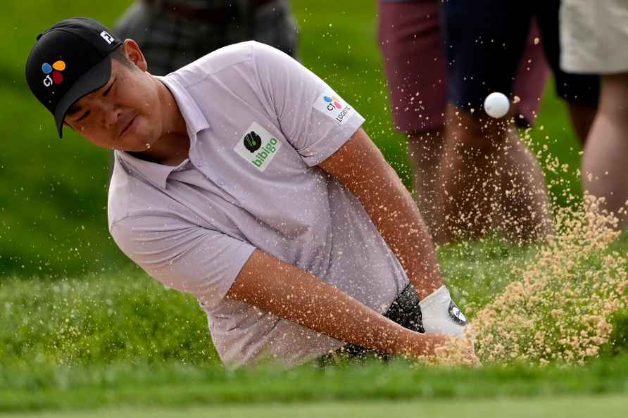 Byeong Hun An, of South Korea, hits from the bunker on the first...