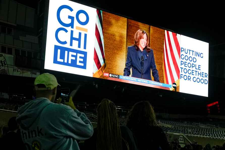 People watch Democratic presidential nominee Vice President Kamala...