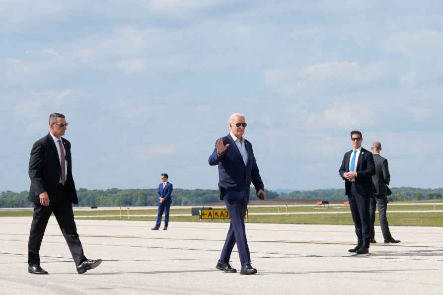 President Joe Biden waves as he walks toward Air Force One at La...