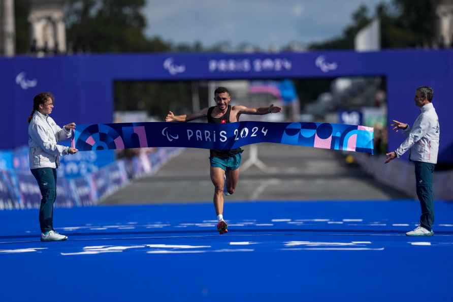 Tunisia's Wajdi Boukhili celebrates as he wins the men's marathon...