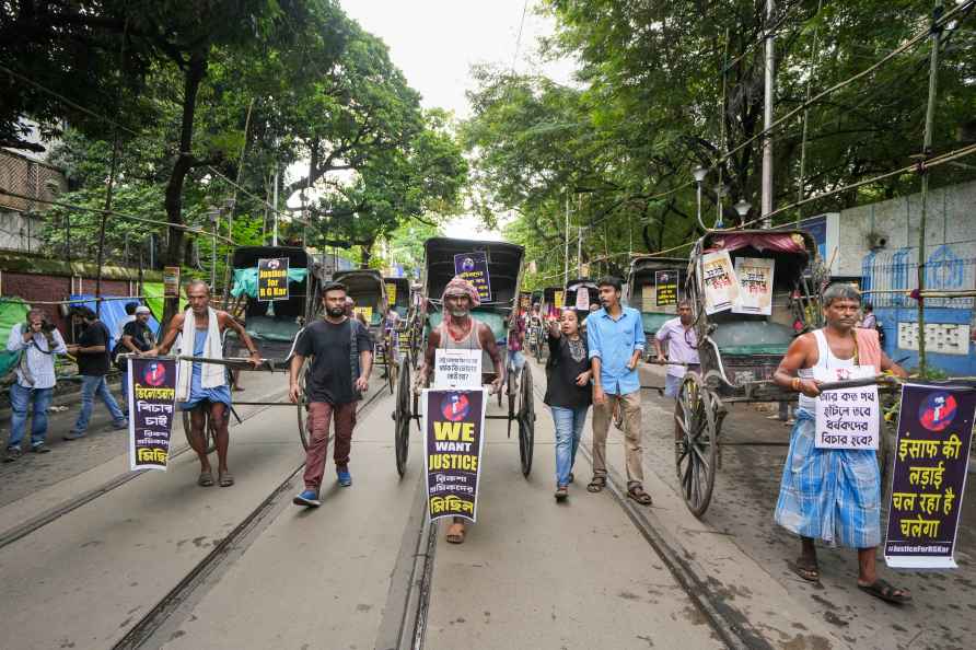 Kolkata: Hand-rickshaw pullers with posters participate in a protest...