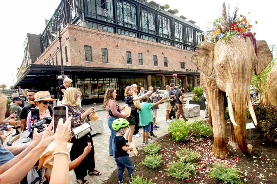 **EDS: WITH STORY** People take pictures of elephants' sculptures...